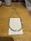 18in green beaded necklace with pearl accents.