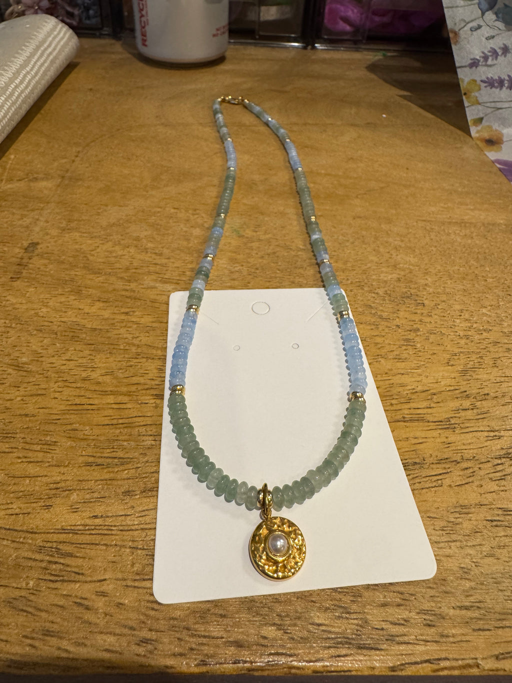 18in blue and green beaded necklace with gold plated pearl charm.