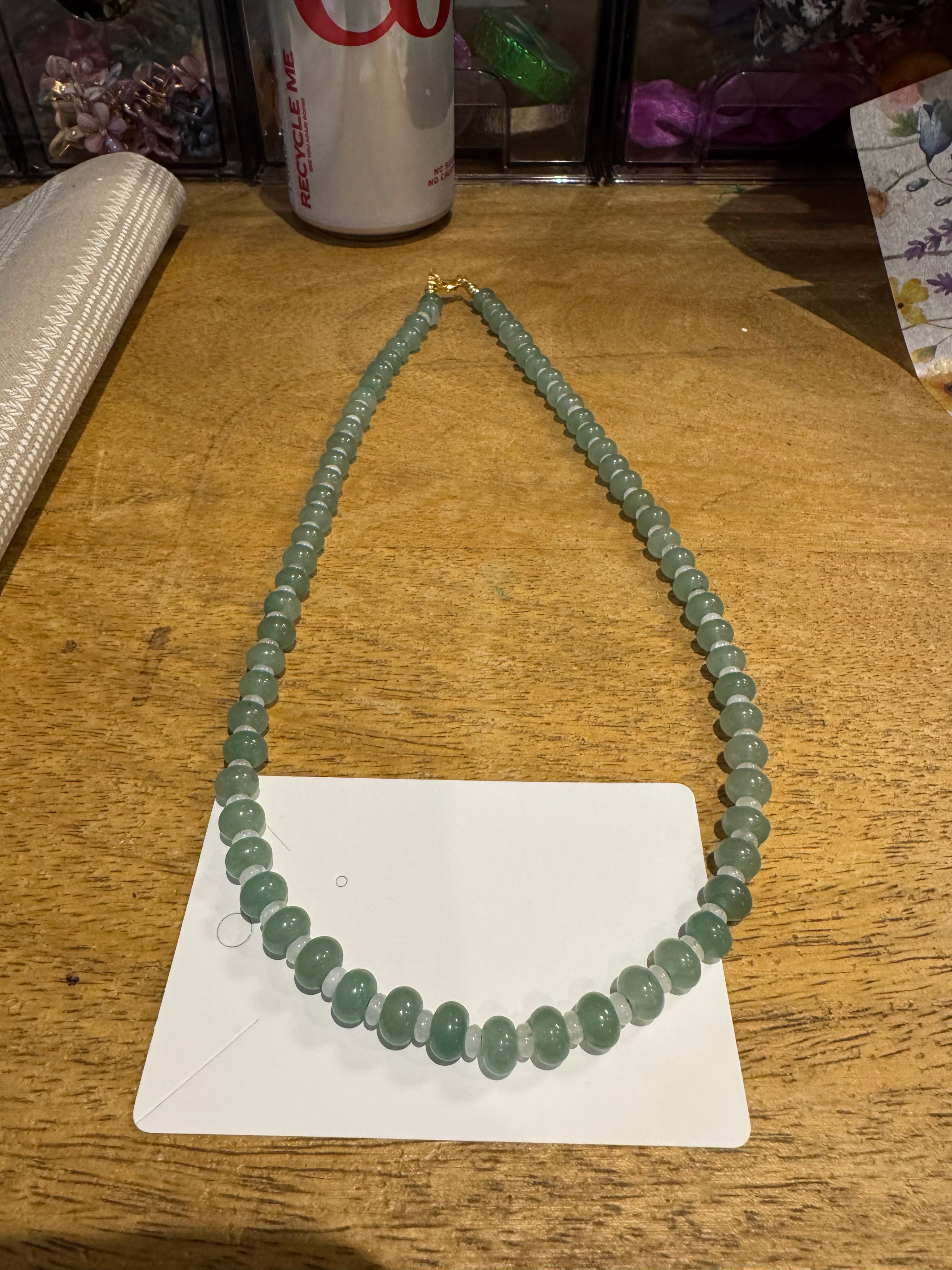 22 in green and white beaded necklace.
