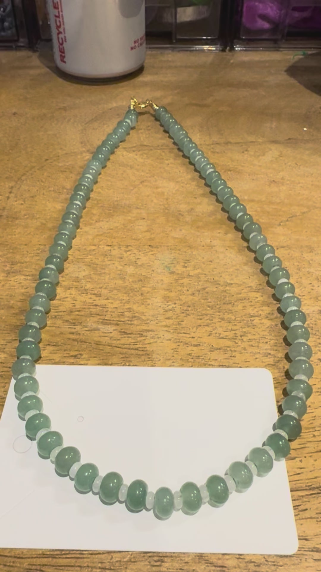 22 in green and white beaded necklace.