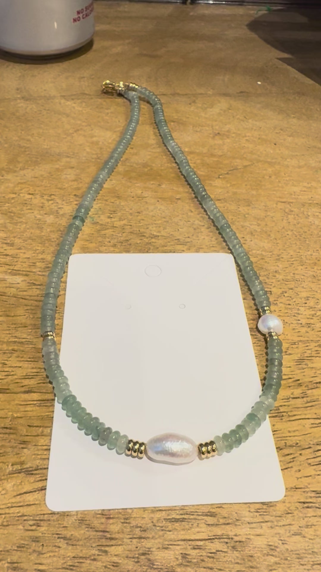 18in green beaded necklace with pearl accents.